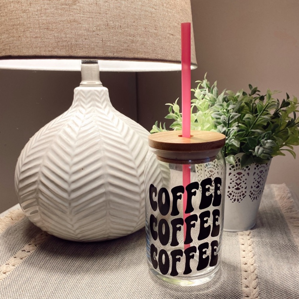 Glass can with bamboo lid and straw